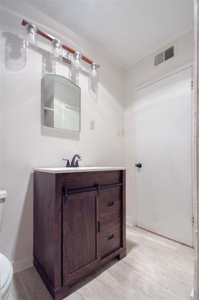 371 Wallace Road Memphis, TN 38117 - Photo 15 of 21 a bathroom with a sink vanity and mirror