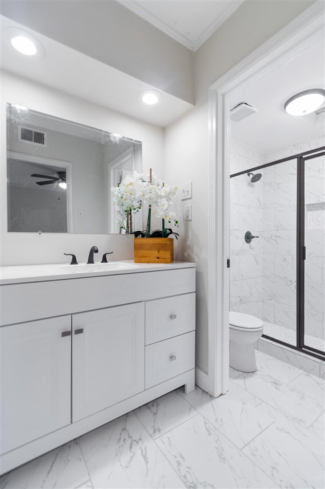 371 Wallace Road Memphis, TN 38117 - Photo 20 of 21 a spacious bathroom with a double vanity sink toilet and shower