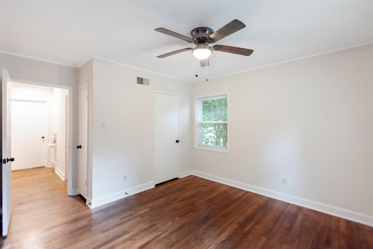 371 Wallace Road Memphis, TN 38117 - Photo 6 of 21 a view of an empty room with wooden floor and a window