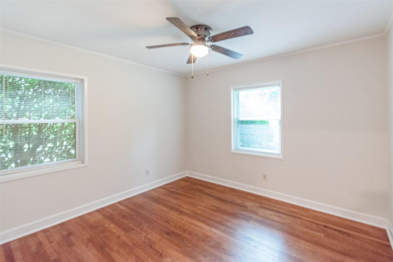 371 Wallace Road Memphis, TN 38117 - Photo 7 of 21 a view of an empty room with wooden floor and a window