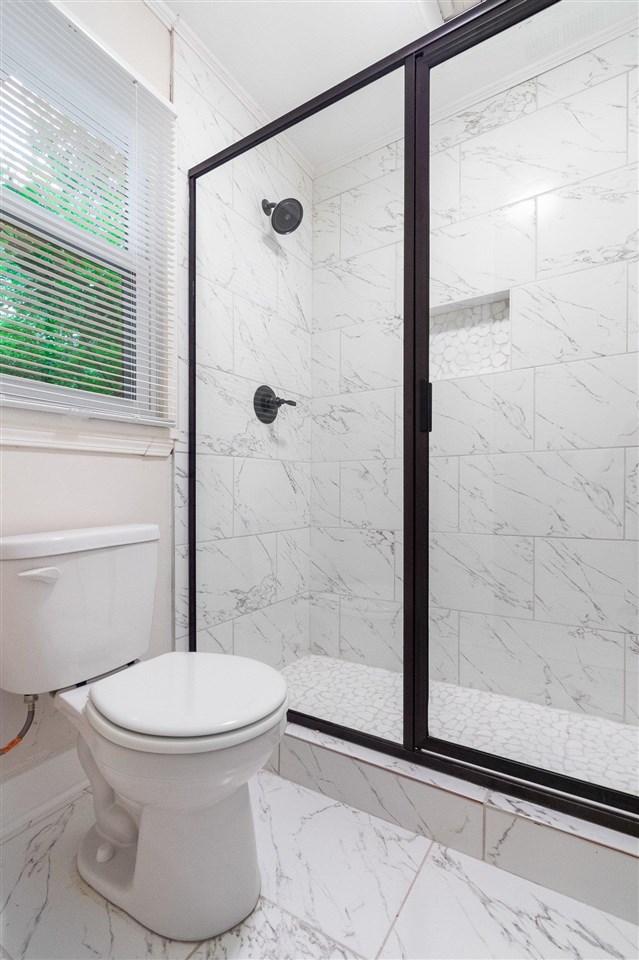 371 Wallace Road Memphis, TN 38117 - Photo 10 of 21 a white toilet sitting next to a bathroom sink