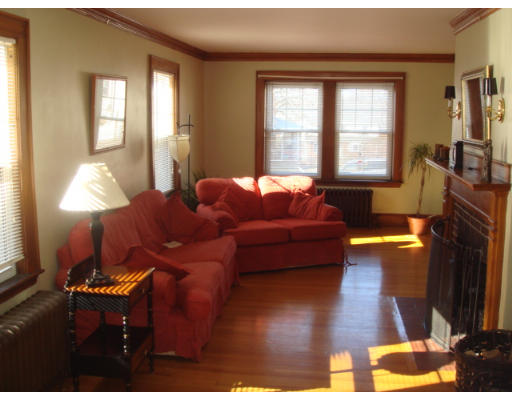 149 Common Street Watertown, MA 02472 - Photo 4 of 19 a living room with furniture and a fireplace