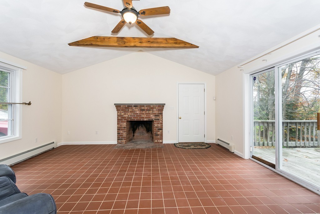 215 Bolton Road Lancaster, MA 01523 - Photo 7 of 14 a view of empty room with wooden floor and fan