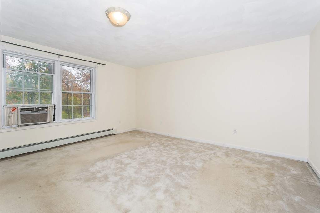 215 Bolton Road Lancaster, MA 01523 - Photo 9 of 14 an empty room with a empty space and a window