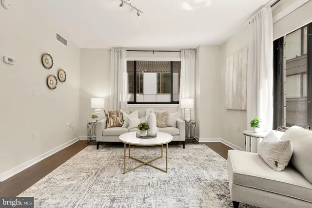 a living room with furniture kitchen and a table