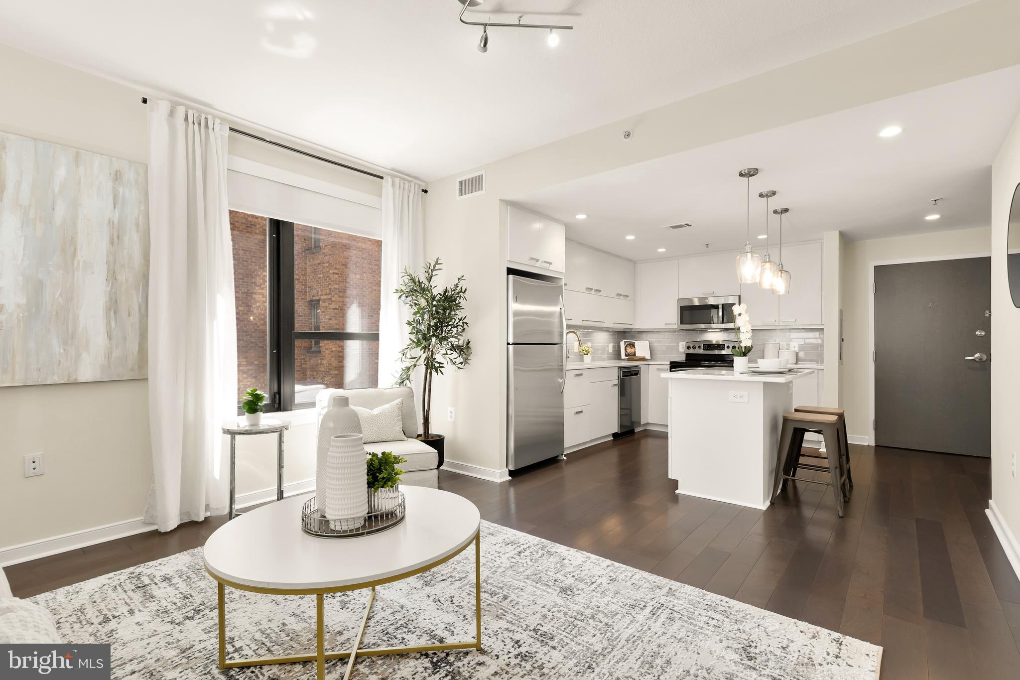 1010 Massachusetts Avenue Northwest, Unit 211 Washington, DC 20001 - Photo 12 of 27 a living room with furniture kitchen and a table