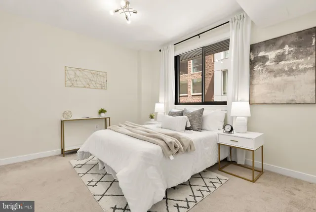 a large white bed in a white room