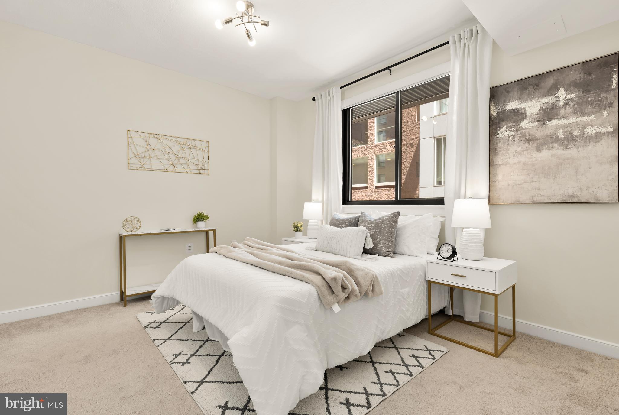 1010 Massachusetts Avenue Northwest, Unit 211 Washington, DC 20001 - Photo 13 of 27 a bedroom with a bed and a painting on the wall