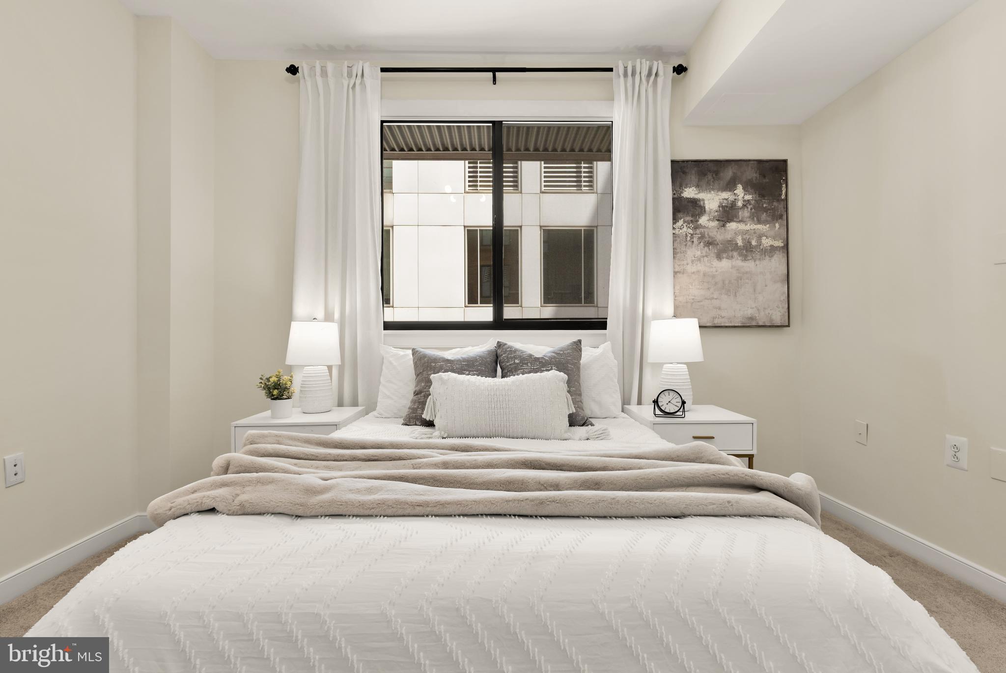 1010 Massachusetts Avenue Northwest, Unit 211 Washington, DC 20001 - Photo 14 of 27 a large white bed in a white room