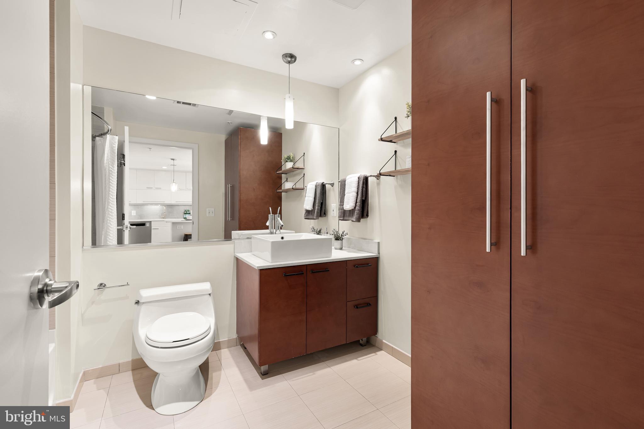 1010 Massachusetts Avenue Northwest, Unit 211 Washington, DC 20001 - Photo 16 of 27 a bathroom with a toilet sink and mirror
