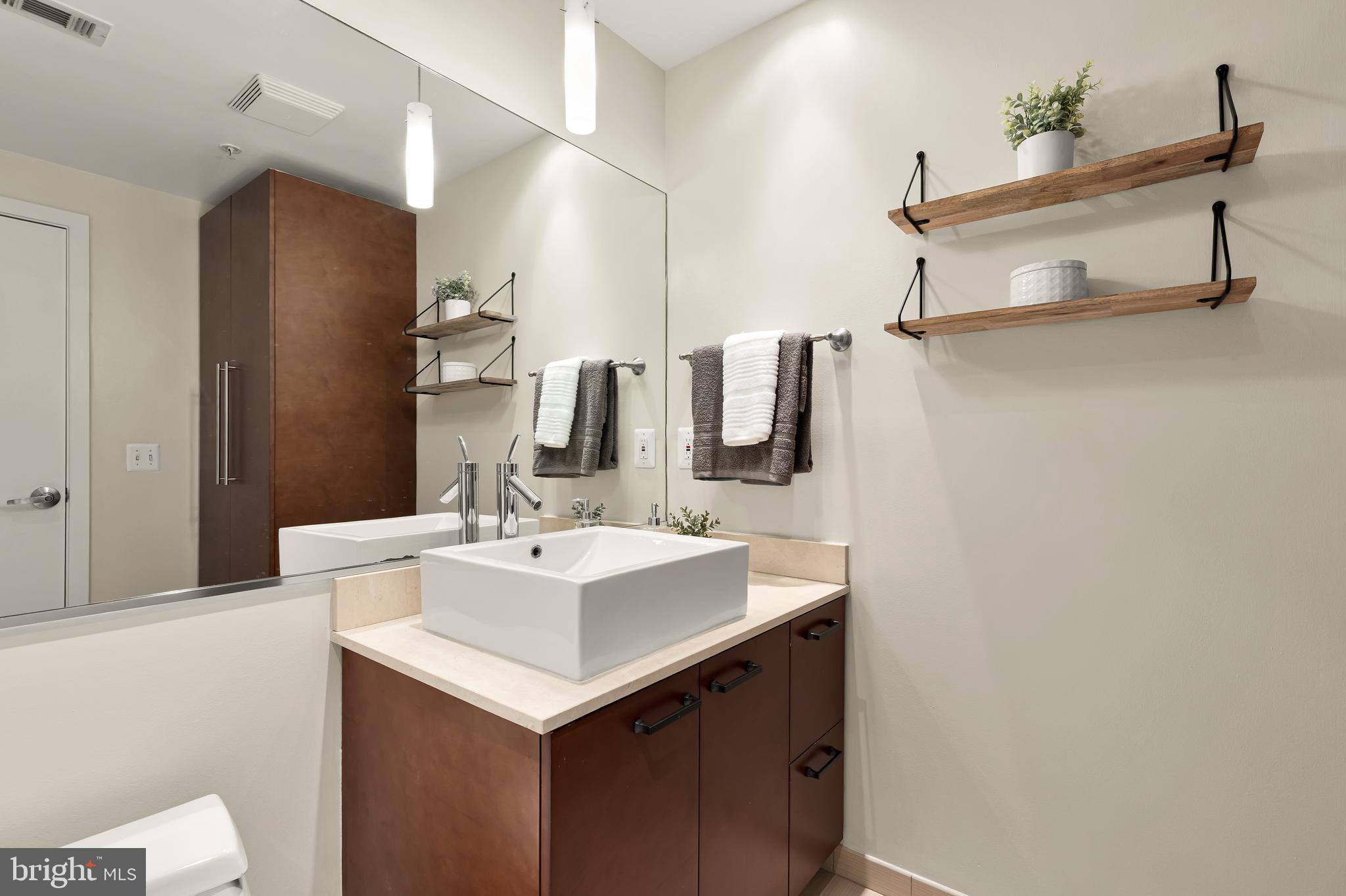 1010 Massachusetts Avenue Northwest, Unit 211 Washington, DC 20001 - Photo 17 of 27 a bathroom with a sink and a mirror