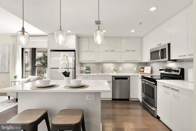 a kitchen with granite countertop counter space a sink appliances and cabinets