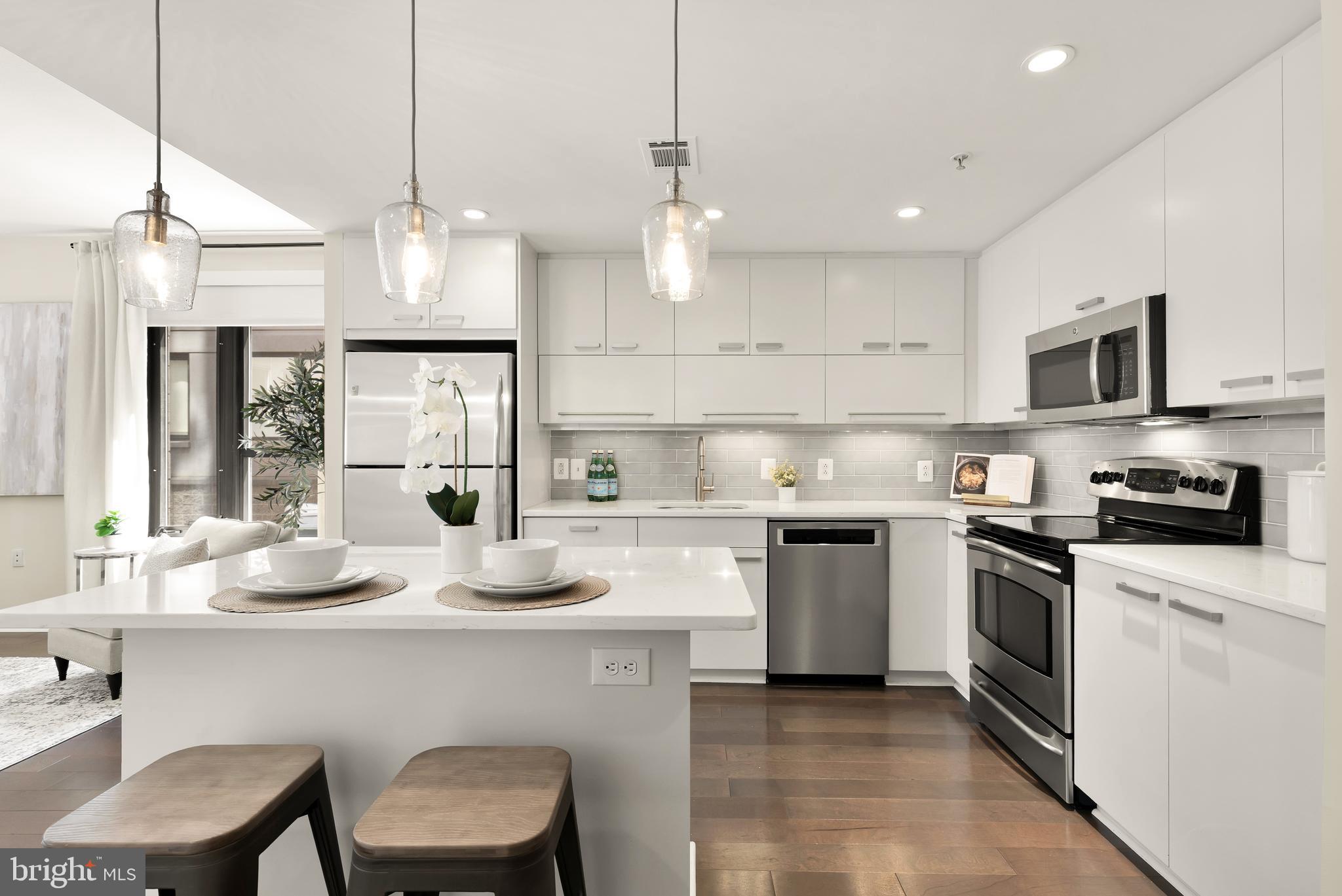 1010 Massachusetts Avenue Northwest, Unit 211 Washington, DC 20001 - Photo 2 of 27 a kitchen with granite countertop counter space a sink appliances and cabinets