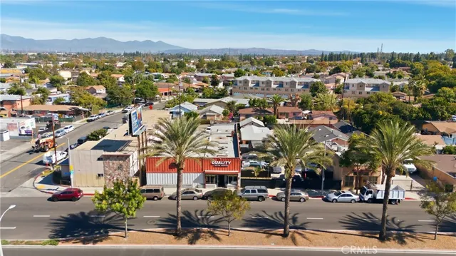 an aerial view of residential houses with outdoor space and parking