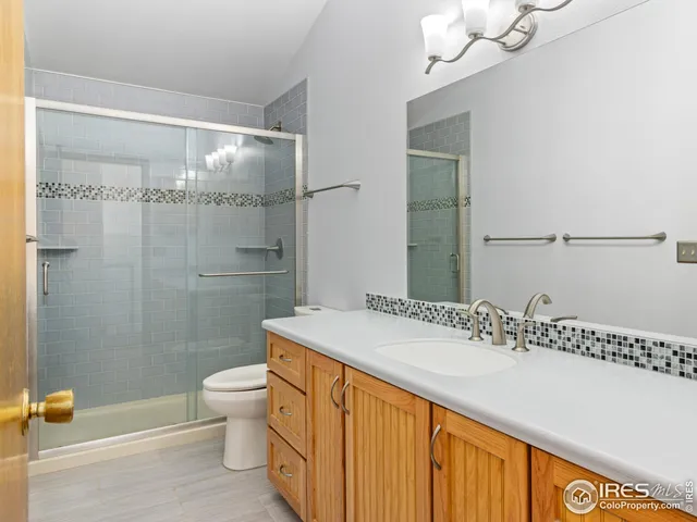 a bathroom with a sink mirror vanity and toilet