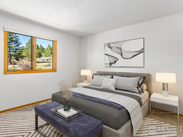 a bedroom with a bed and a large window