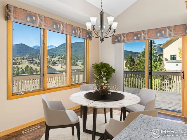 a dining room with furniture a chandelier and window