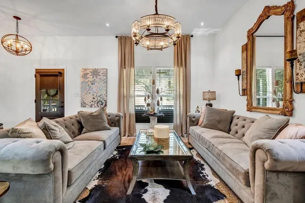 a living room with furniture or couch and a chandelier