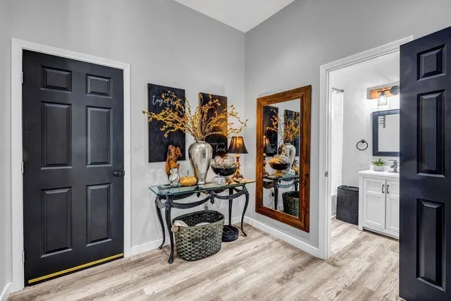 a view of a livingroom with wooden floor and furniture