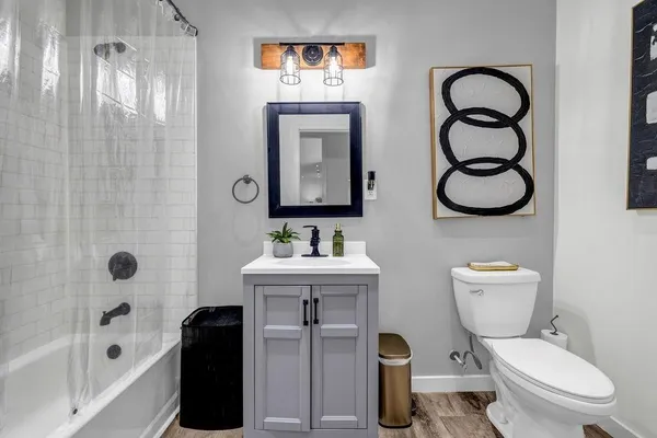 a bathroom with a toilet sink and shower