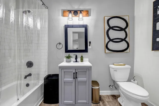 a bathroom with a toilet sink and shower