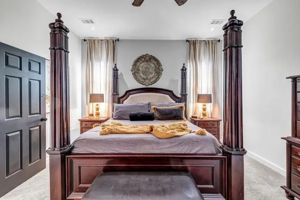 a bed sitting in a bedroom next to a window