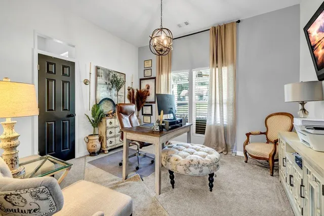 a living room with furniture a window and a chandelier
