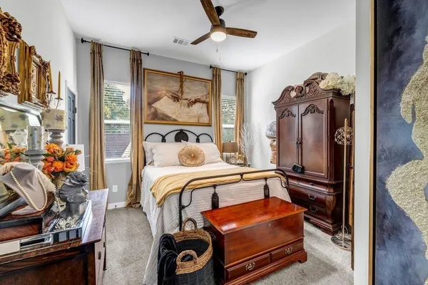 a bedroom with bed and wooden floor