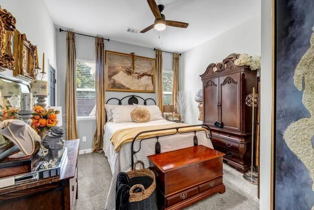 a bedroom with bed and wooden floor