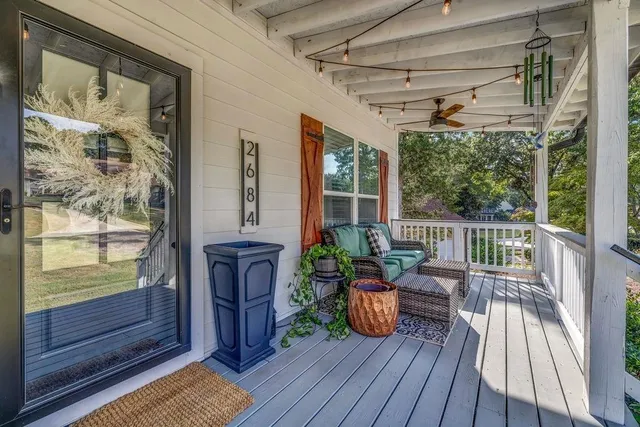 a view of a porch with wooden floor and furniture