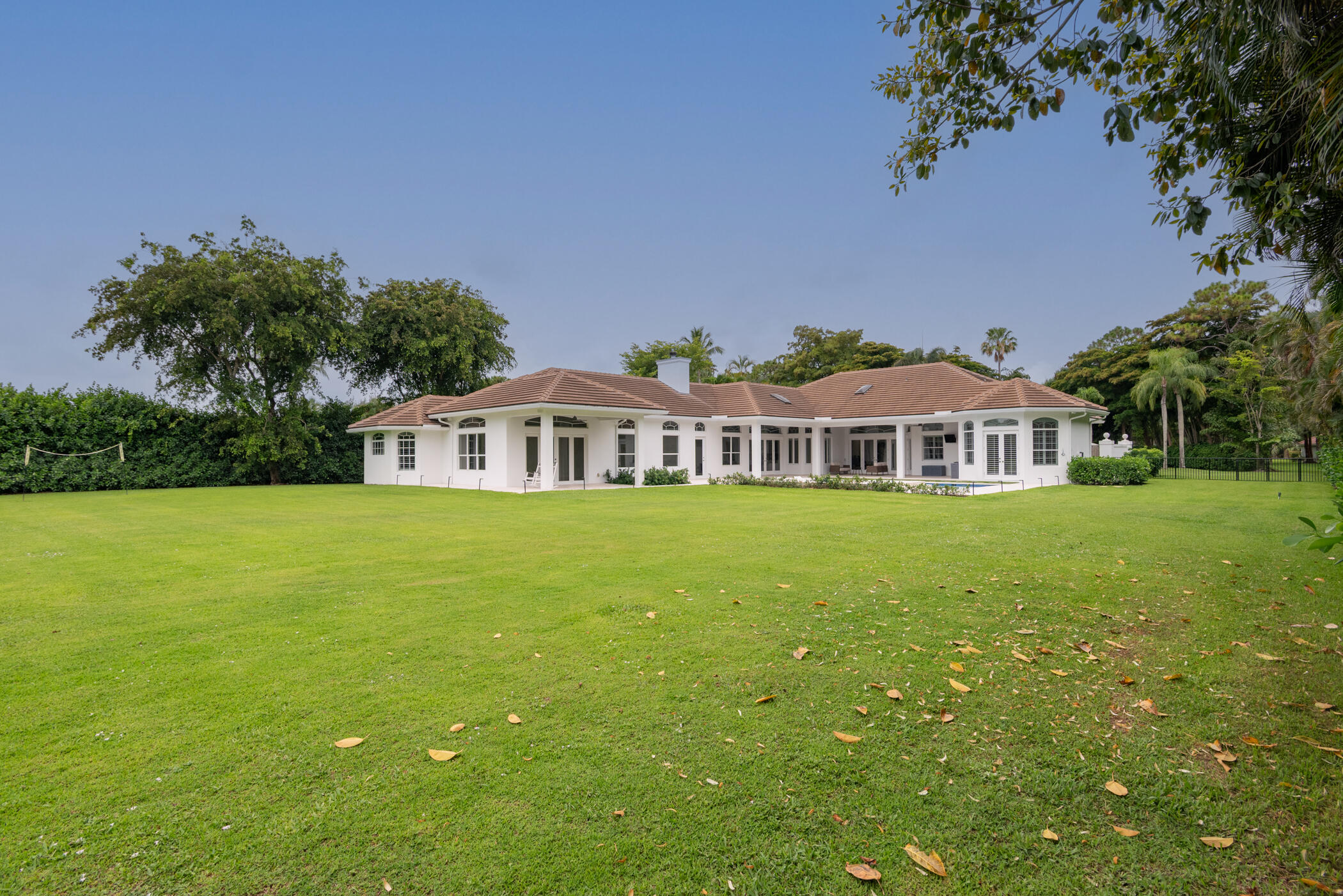 8246 Man O War Road Palm Beach Gardens, FL 33418 - Photo 3 of 55 a front view of a house with garden