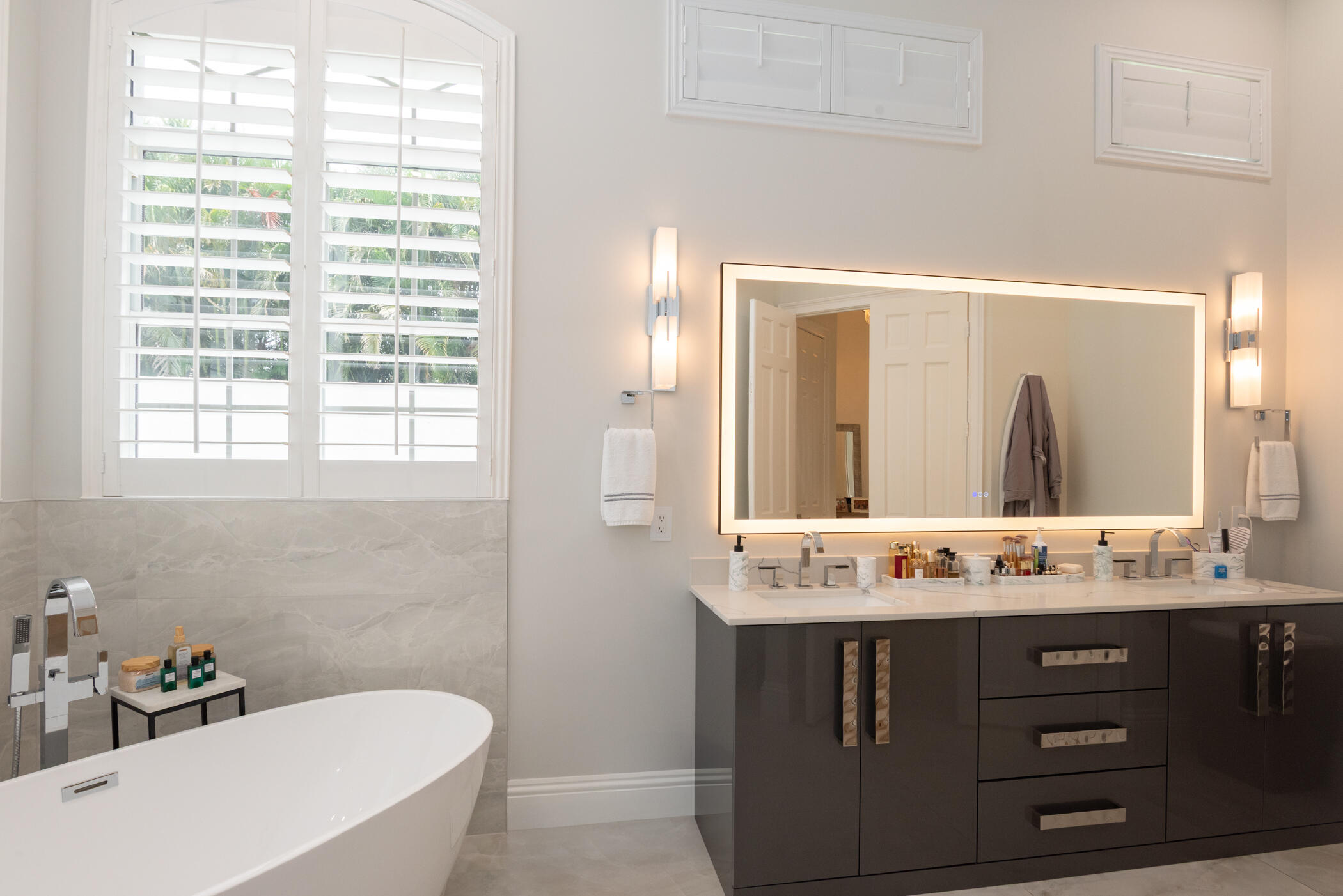 8246 Man O War Road Palm Beach Gardens, FL 33418 - Photo 35 of 55 a bathroom with a sink vanity granite tub and a mirror