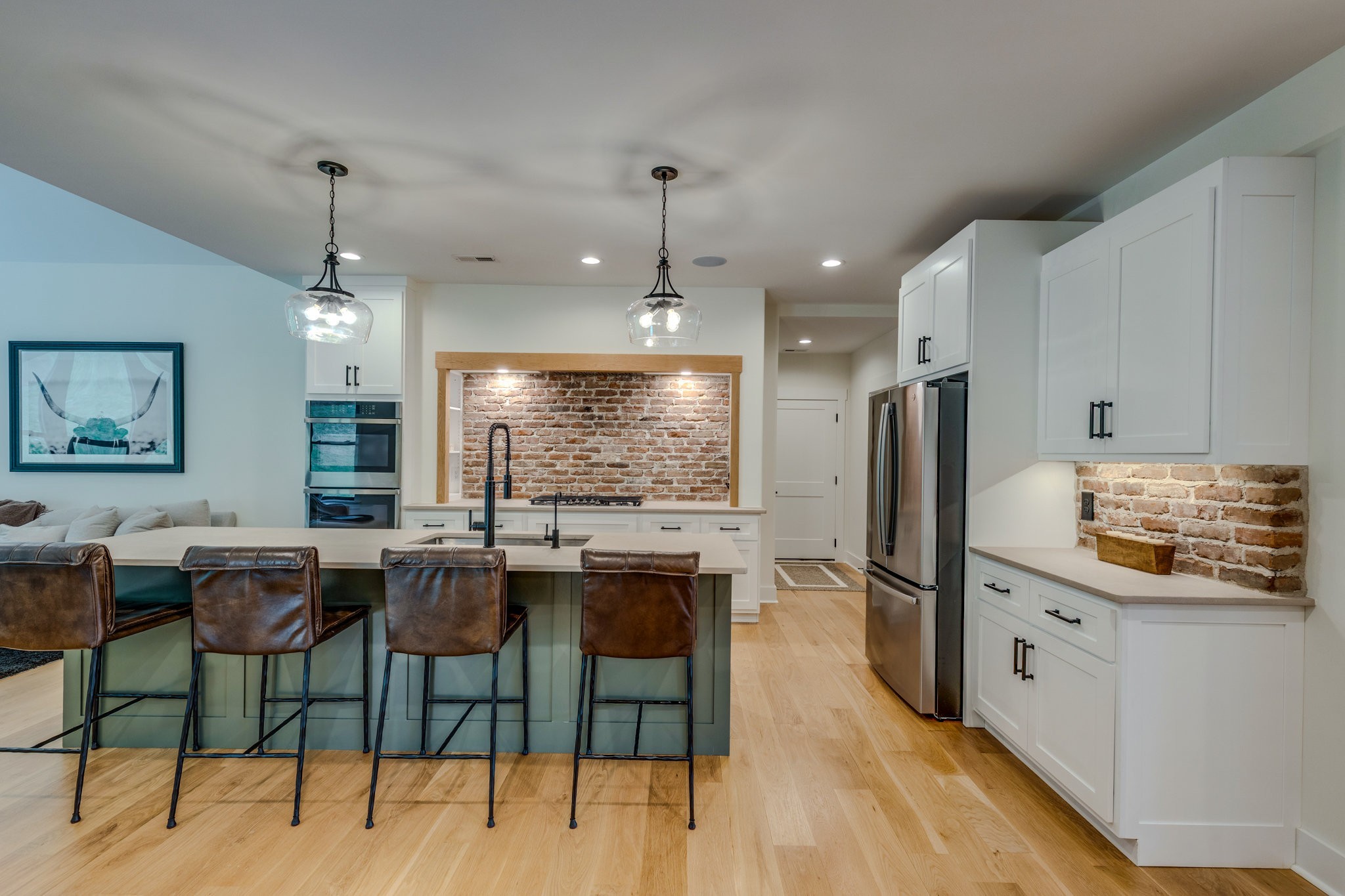 564 Mt Olive Cemetery Road Lynnville, TN 38472 - Photo 13 of 96 a kitchen with stainless steel appliances kitchen island granite countertop a stove a refrigerator a oven a sink with island chairs and wooden floor