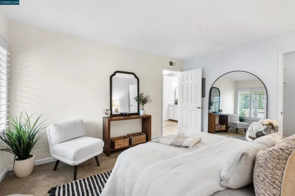 a bedroom with bed a table and a couch