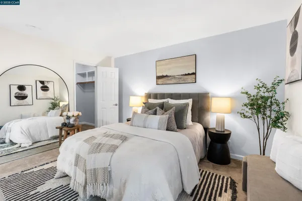 a bedroom with a bed and a potted plant