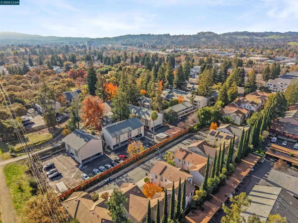 an aerial view of residential houses with city view