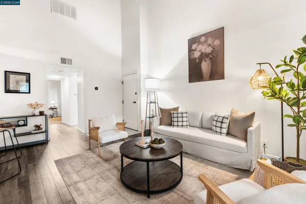 a living room with furniture and a dining room