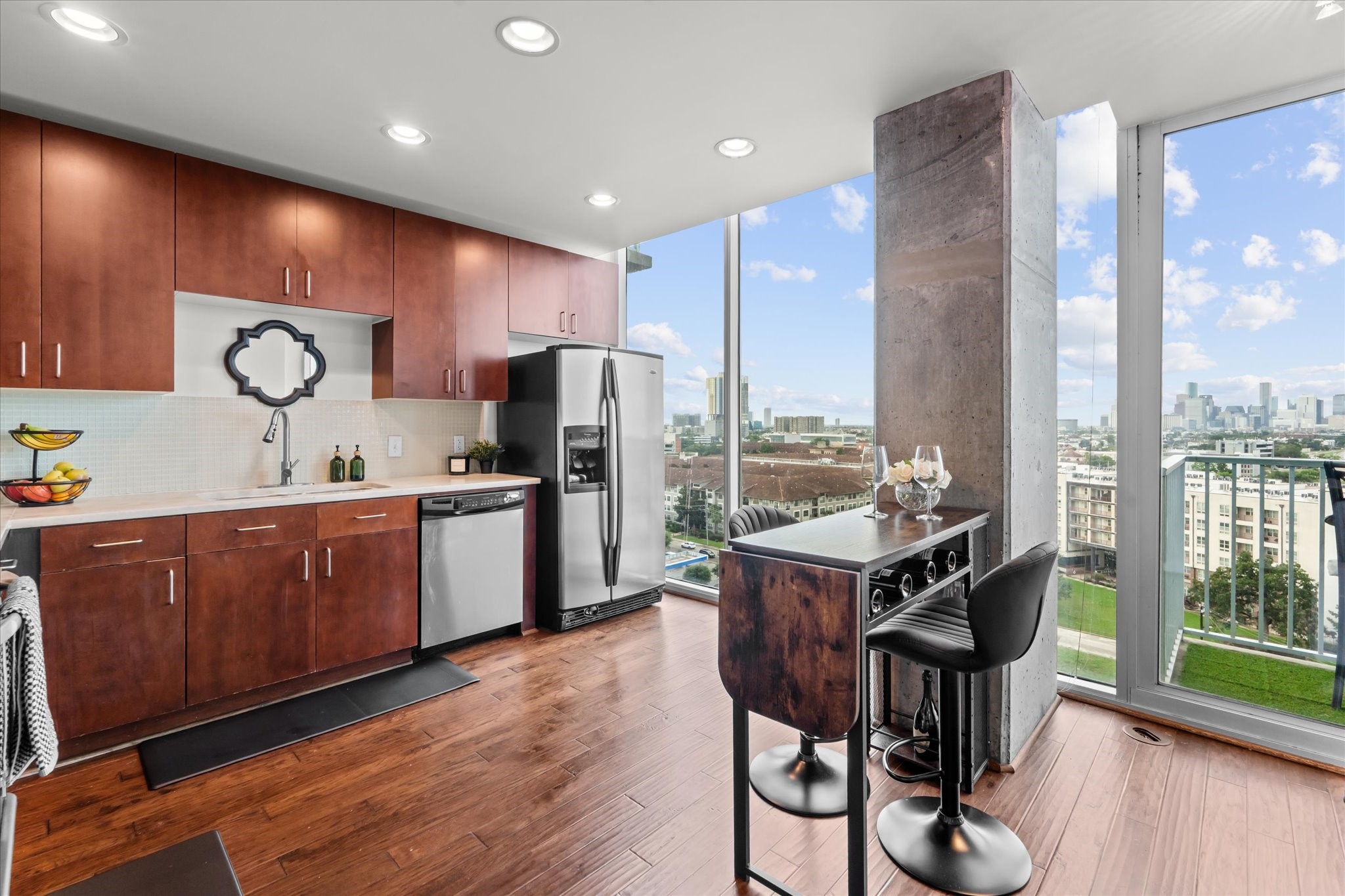 5925 Almeda Road, Unit 11107 Houston, TX 77004 - Photo 14 of 45 a kitchen with stainless steel appliances a stove a refrigerator a sink with wooden cabinets and wooden floor