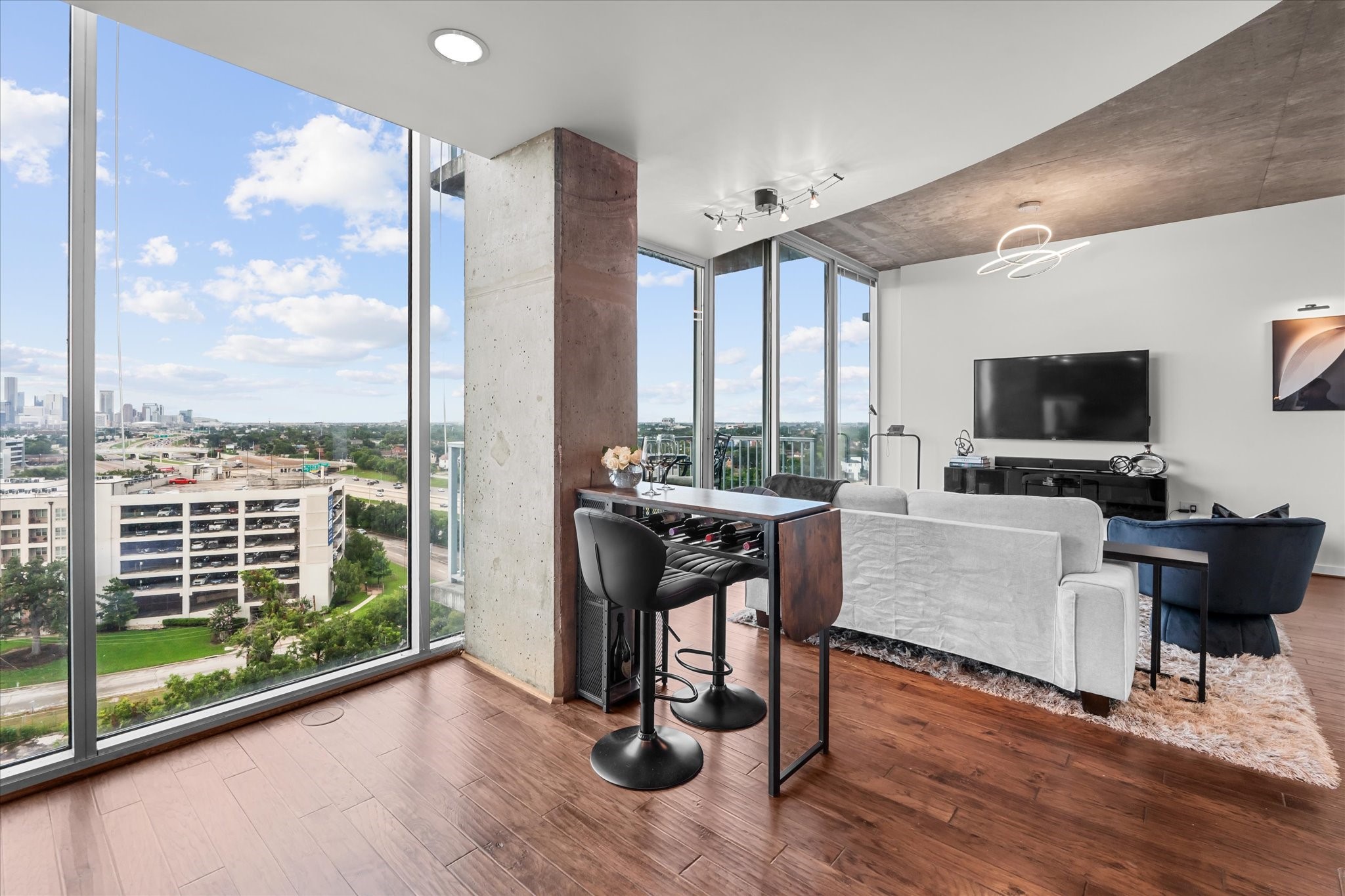 5925 Almeda Road, Unit 11107 Houston, TX 77004 - Photo 16 of 45 a view of a livingroom with furniture flat screen tv and floor to ceiling window