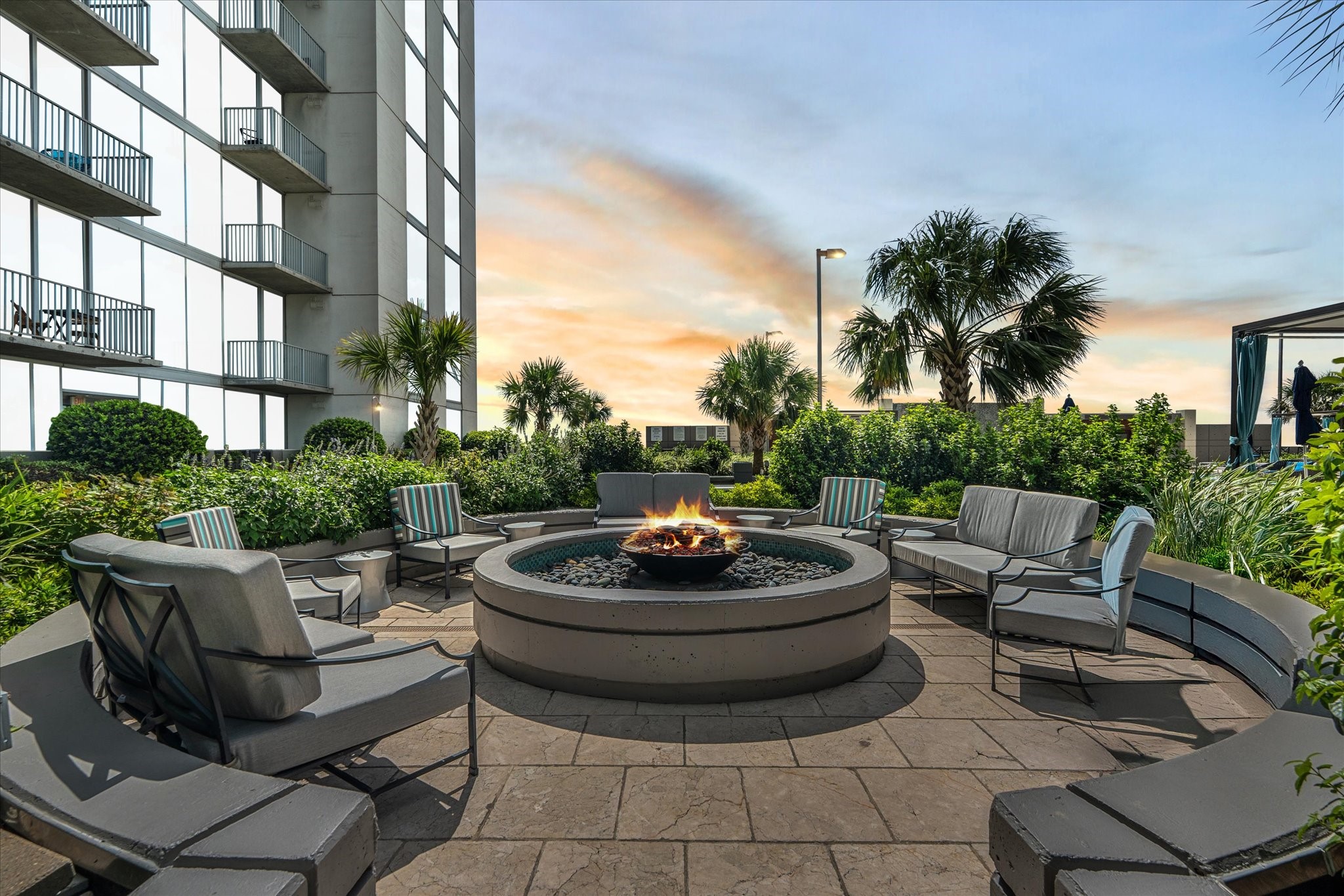 5925 Almeda Road, Unit 11107 Houston, TX 77004 - Photo 30 of 45 a view of a patio with couches and a fire pit and potted plants