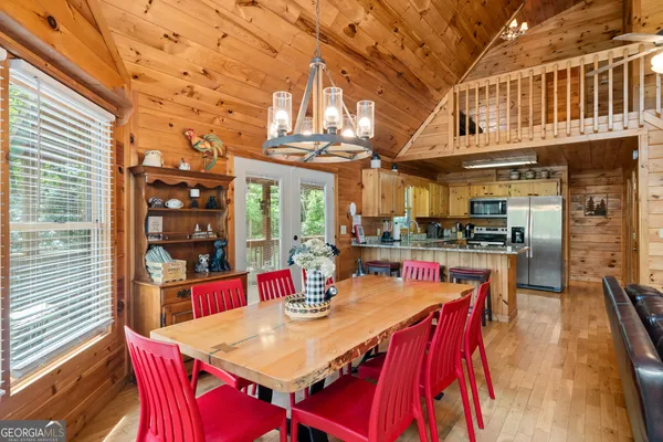 a kitchen with stainless steel appliances granite countertop a sink a stove and refrigerator