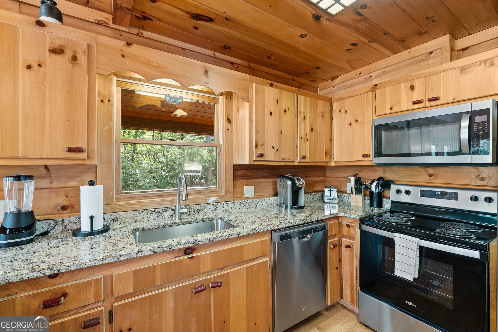 476 Prince Mountain Road Cherry Log, GA 30522 - Photo 20 of 80 a kitchen with stainless steel appliances granite countertop a sink a stove a microwave and wooden cabinets