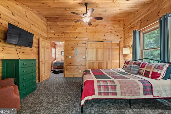 a bedroom with bunk bed and a window