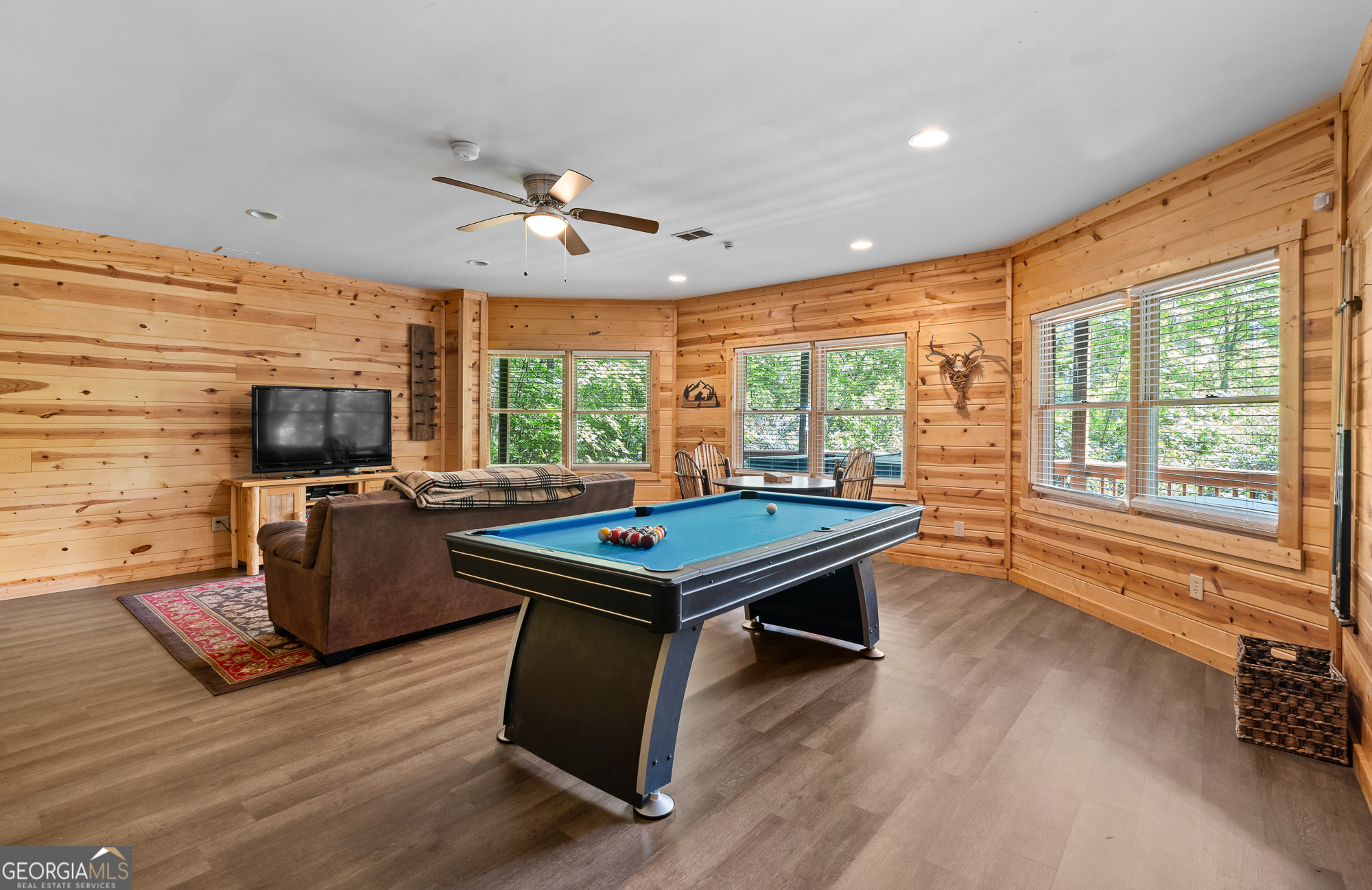 476 Prince Mountain Road Cherry Log, GA 30522 - Photo 41 of 80 a living room with furniture a flat screen tv and a floor to ceiling window