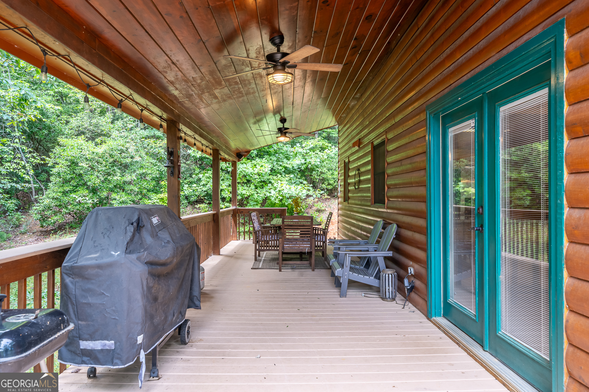 476 Prince Mountain Road Cherry Log, GA 30522 - Photo 52 of 80 a view of patio with table and chairs potted plants and floor to ceiling window