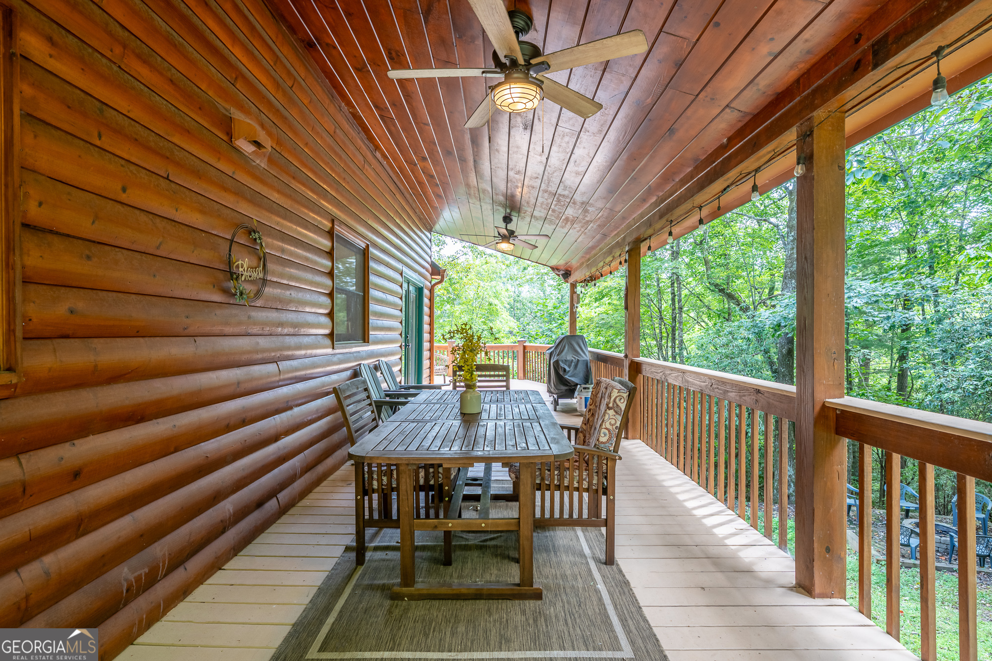 476 Prince Mountain Road Cherry Log, GA 30522 - Photo 54 of 80 a view of a patio with table and chairs and wooden floor