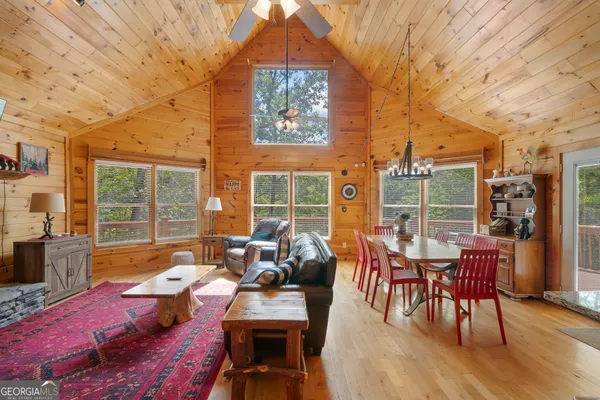 a view of a patio with couches table and chairs and potted plants