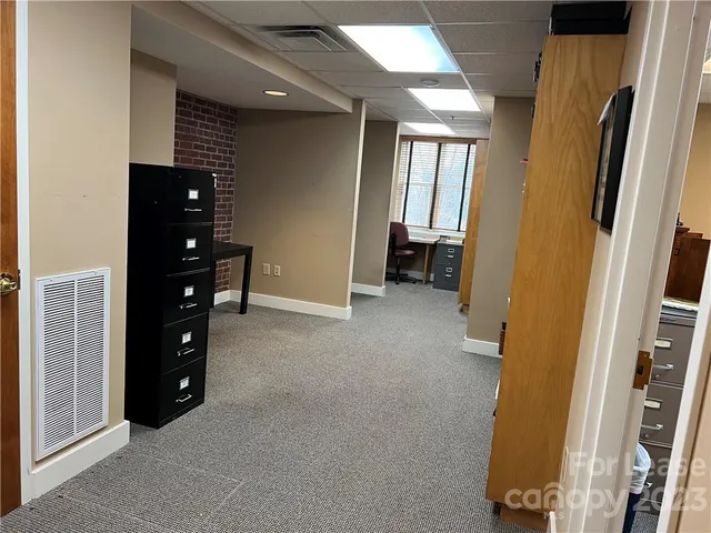 a view of an empty room with closet and a window