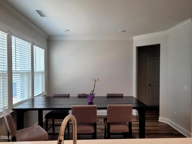a view of a dining room with furniture and window