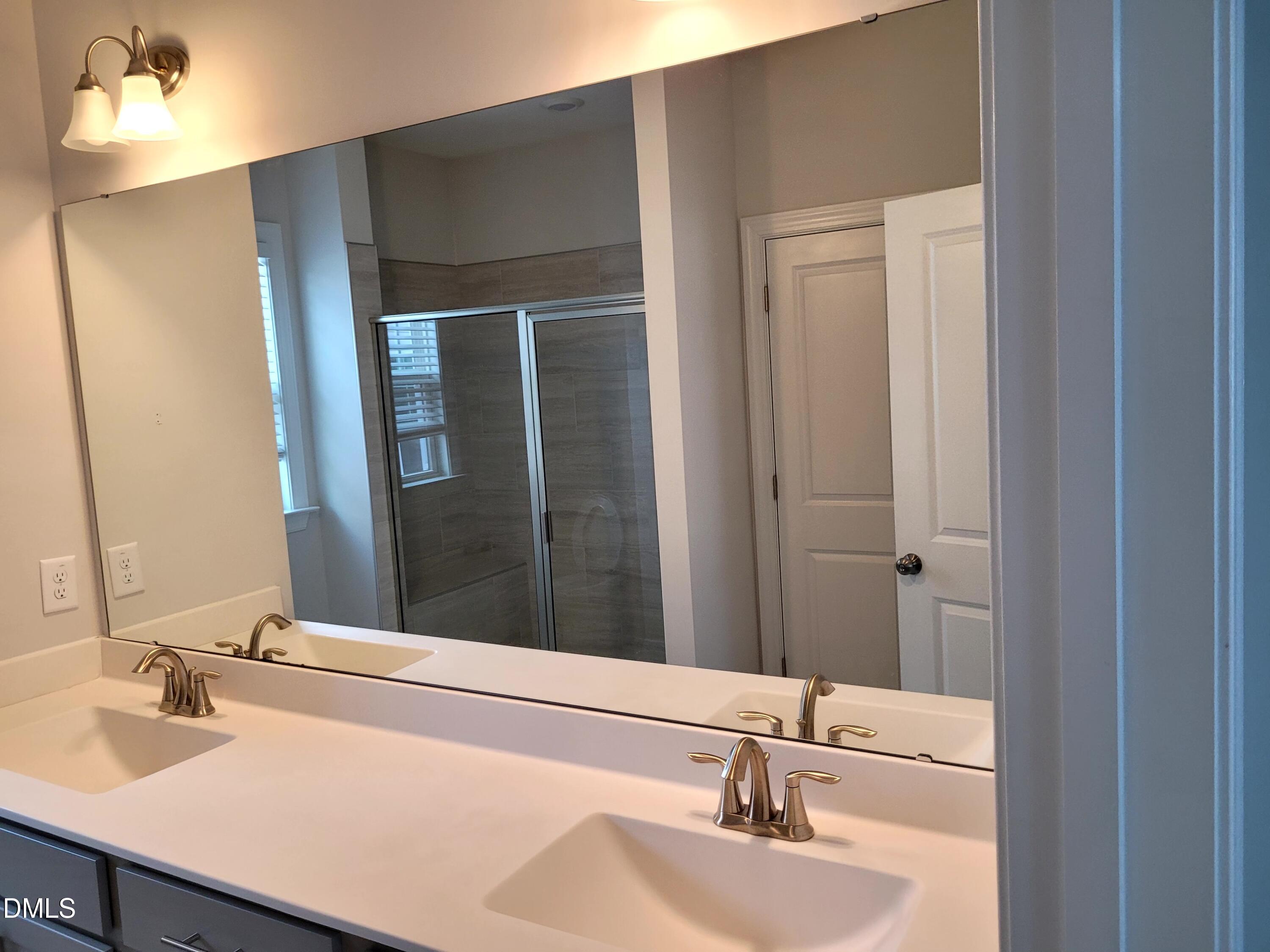 5220 Influence Way Raleigh, NC 27616 - Photo 6 of 10 a bathroom with a sink and a mirror